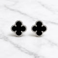 Sterling silver black quatrefoil clover stud earrings front pair with beaded border on marble surface