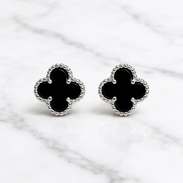 Sterling silver black quatrefoil clover stud earrings front pair with beaded border on marble surface