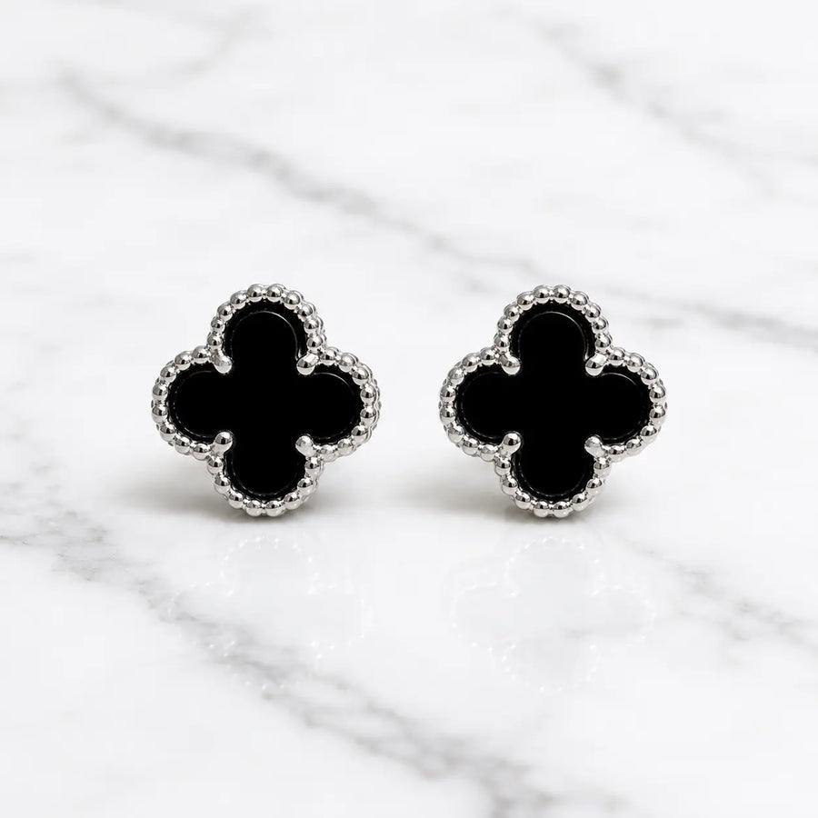 Sterling silver black quatrefoil clover stud earrings front pair with beaded border on marble surface