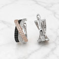 Sterling silver black and white CZ crisscross clip earrings front and back view on marble surface