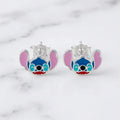 Sterling silver blue alien enamel stud earrings front view with pink ears on marble surface