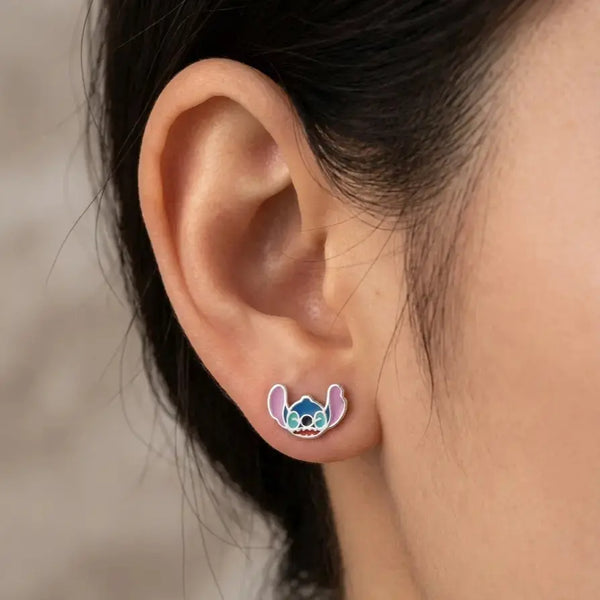 Sterling silver blue alien enamel stud earring worn on ear showing petite colorful style