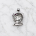 Back view of sterling silver cat pendant with open gallery and pink bow detail on white marble surface