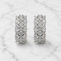 Sterling silver CZ lattice hoop earrings front pair with clear round stones on marble surface