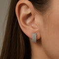 Sterling silver CZ lattice hoop earring worn on ear showing wide 16.3mm size and sparkle