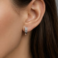 Sterling silver double-row CZ huggie earring worn on ear showing close everyday fit