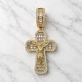 Gold tone sterling silver crucifix pendant with baguette and round CZ stones shown from the front on marble surface