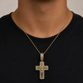 Gold tone sterling silver baguette CZ crucifix pendant worn on a chain over a black shirt