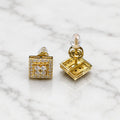 Sterling silver gold-tone moissanite square halo stud earrings showing front and screw-back closure on marble surface