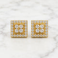 Sterling silver gold-tone moissanite square halo stud earrings with floral center on marble surface