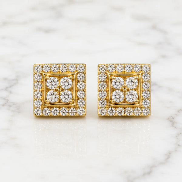 Sterling silver gold-tone moissanite square halo stud earrings with floral center on marble surface
