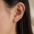 Sterling silver gold-tone moissanite square halo screw-back stud earring worn on ear showing size and fit