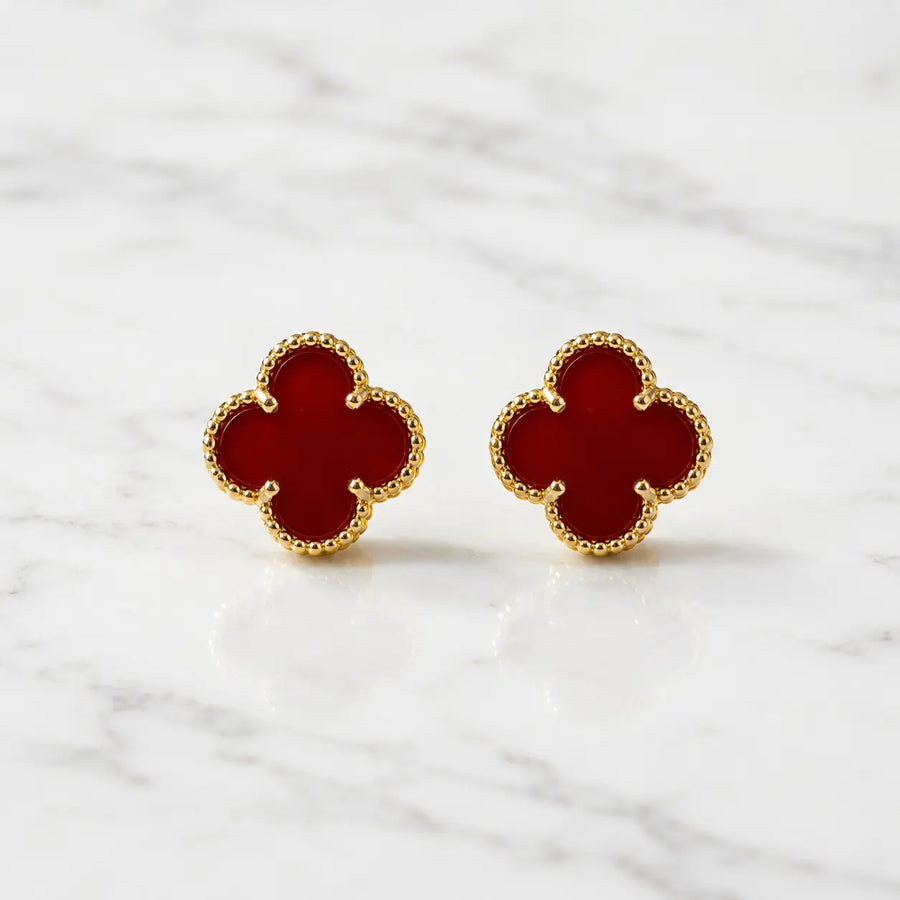 Sterling silver gold-tone red clover stud earring worn on ear showing 12mm quatrefoil size
