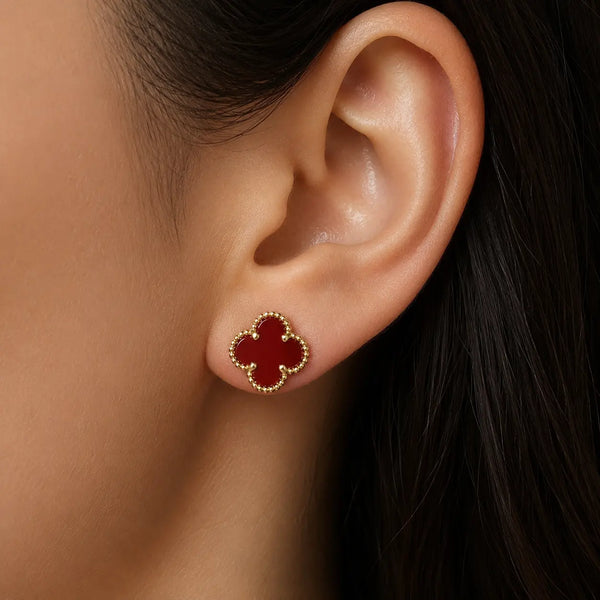 Sterling silver gold-tone red clover stud earrings front pair with beaded border on marble surface
