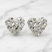 Sterling silver large diamond-cut heart stud earrings front view pair on marble surface