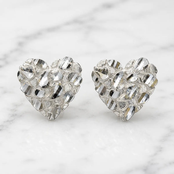 Sterling silver large diamond-cut heart stud earrings front view pair on marble surface