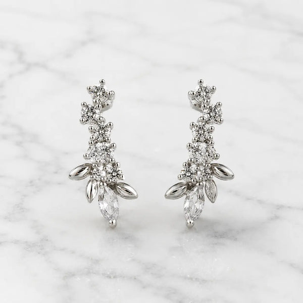 Sterling silver marquise CZ floral stud earrings front pair with round CZ accents on marble surface