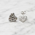 Sterling silver medium diamond-cut heart stud earrings front and back view on marble surface