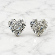 Sterling silver medium diamond-cut heart stud earrings front view pair on marble surface