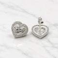 Sterling silver heart CZ stud earrings front and back view with push-back post on marble surface