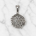 Back view of sterling silver chief head pendant showing open CZ settings and polished profile on marble surface