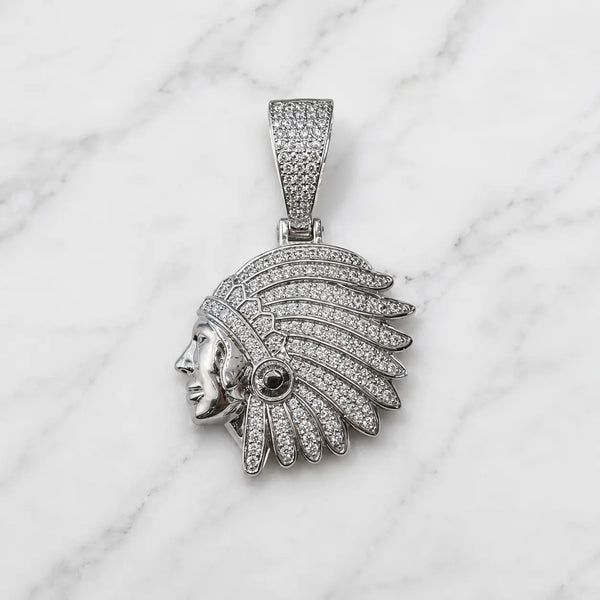 Sterling silver chief head pendant with clear pavé CZ feathers and black CZ accent on marble surface