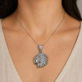 Sterling silver CZ chief head pendant worn on a thin chain at the neckline showing size and fit