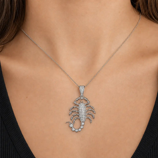 Sterling silver CZ scorpion pendant worn on a thin chain at the neckline showing its statement-size design