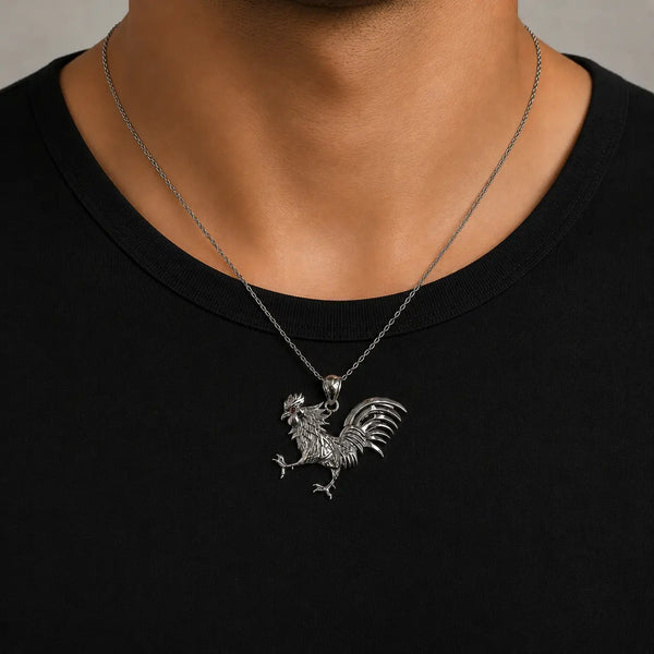 Sterling silver rooster pendant with red CZ eye accent worn on a thin chain showing size and fit