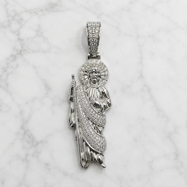 Sterling silver Saint Jude pendant with pavé CZ halo, robe, and bail on marble surface
