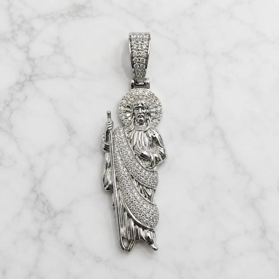 Sterling silver Saint Jude pendant with pavé CZ halo, robe, and bail on marble surface