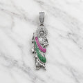 Sterling silver Saint Jude pendant with clear halo and pink and green CZ robe on marble surface