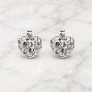 Sterling silver small diamond-cut heart stud earrings front view pair on marble surface