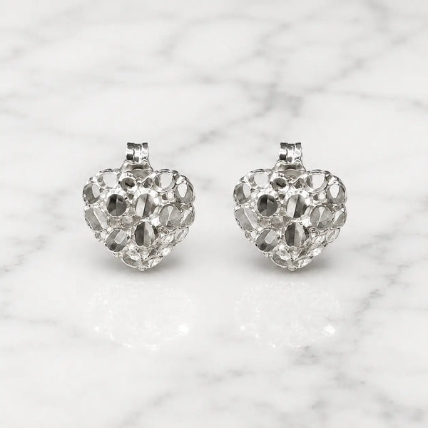 Sterling silver small diamond-cut heart stud earrings front view pair on marble surface