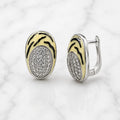 Sterling silver tiger stripe earrings with pavé cubic zirconia oval design and leverback closure on marble surface