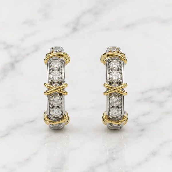 Sterling silver two-tone CZ crossover screw-back earrings front pair with yellow-tone wraps on marble surface