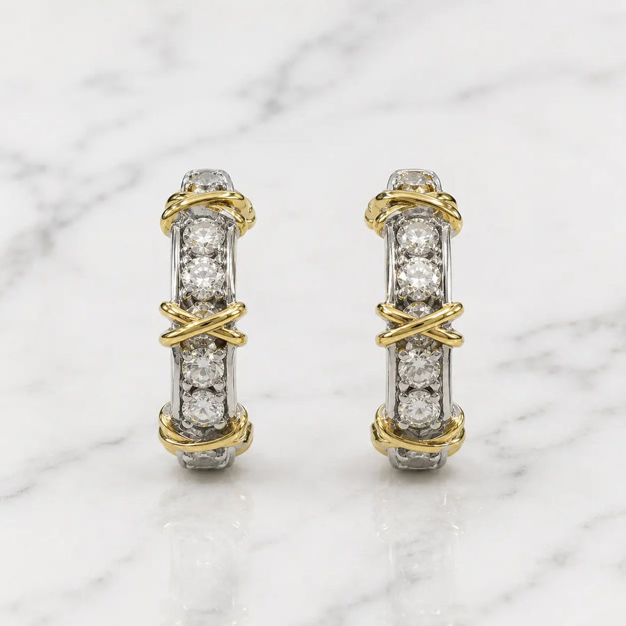Sterling silver two-tone CZ crossover screw-back earrings front pair with yellow-tone wraps on marble surface