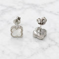 Sterling silver white clover stud earrings front and back view on marble surface
