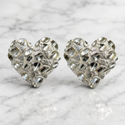 Sterling silver x-large diamond-cut heart stud earrings front view pair on marble surface