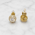 Yellow gold tone sterling silver moissanite halo stud earrings shown front and back on white marble surface
